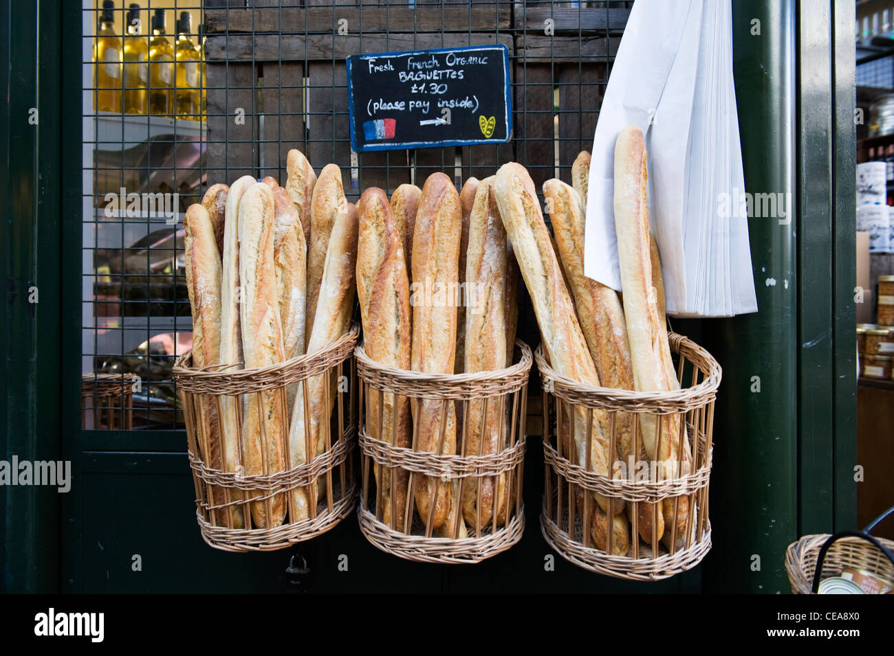 Borough Market London French food shop store fresh organic baguette bread in traditional baskets Stock Photo