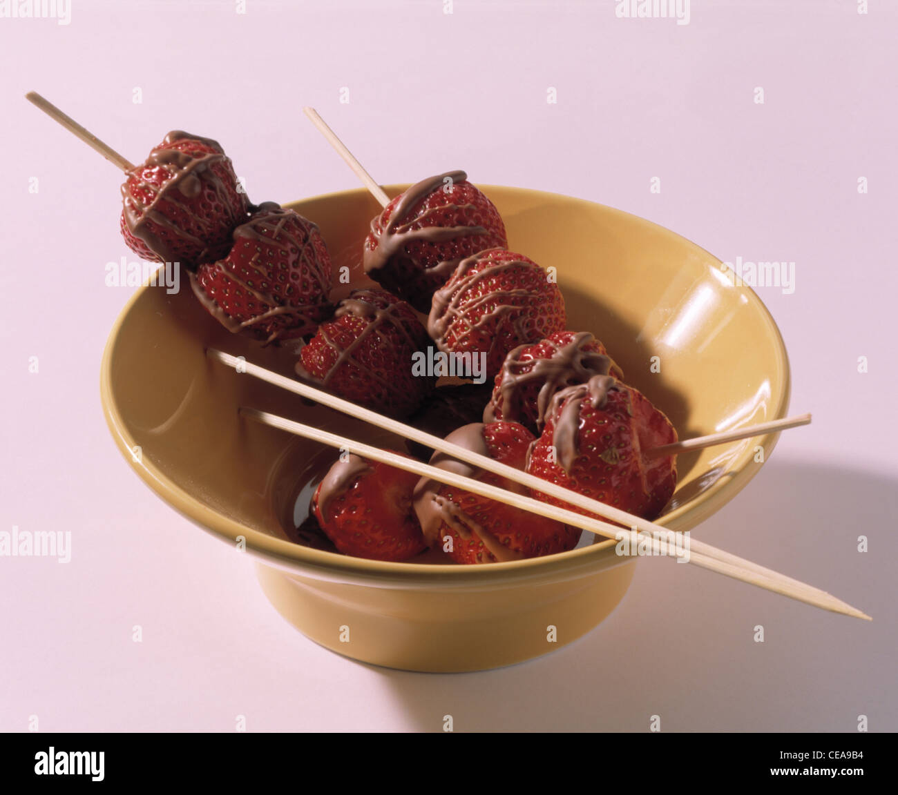 Strawberries with chocolate glaze on stick Stock Photo Alamy