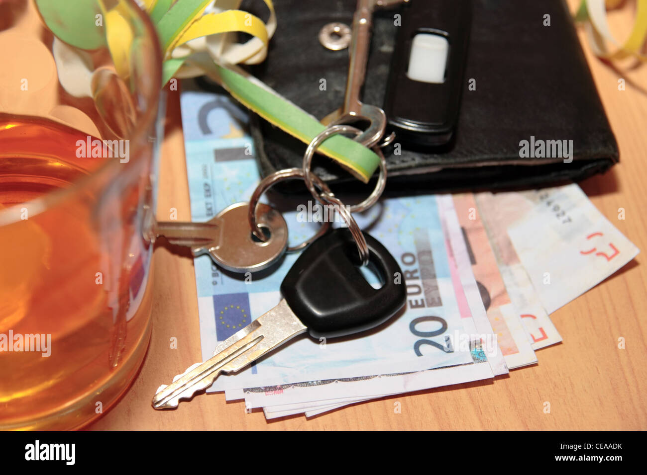 wallet whiskey glass and keys at office party on desk depicting dont drink and drive Stock Photo