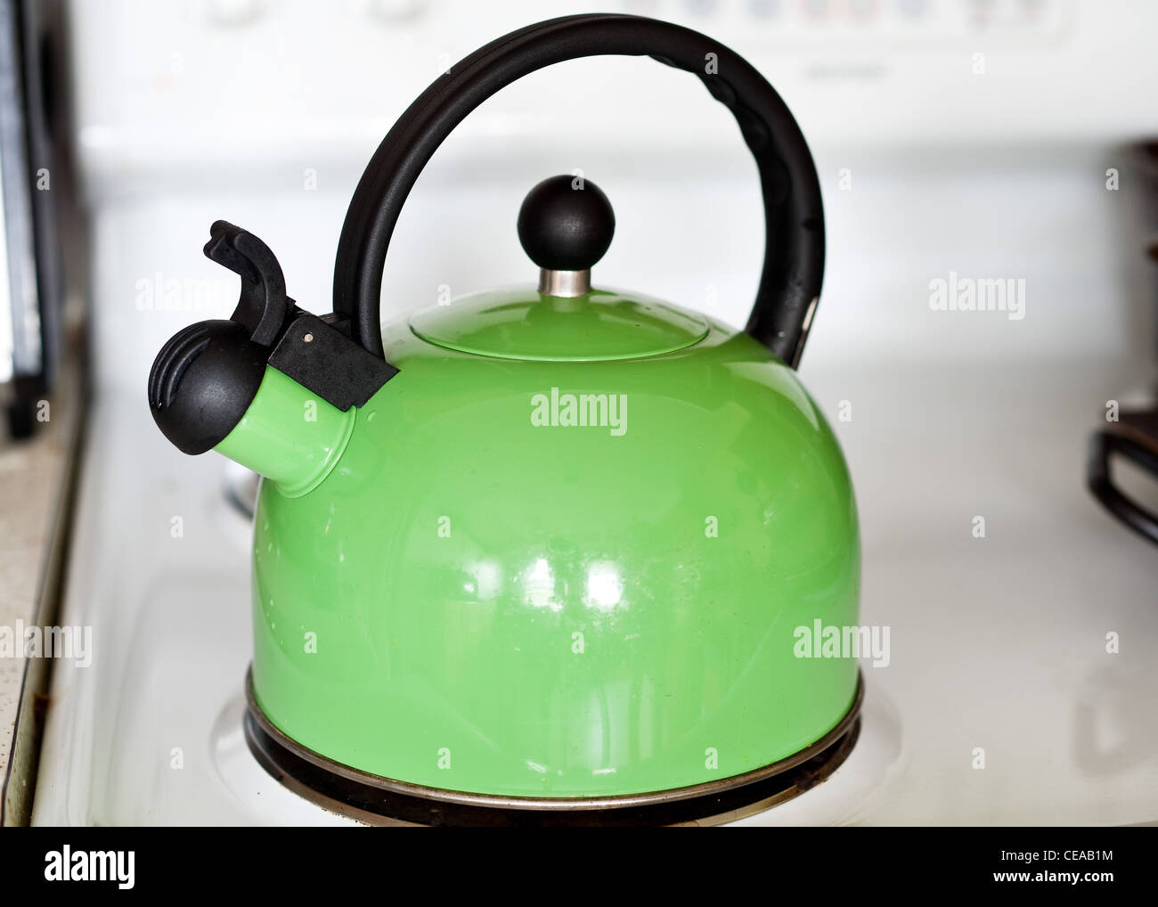 A tea kettle sitting on a stove Stock Photo