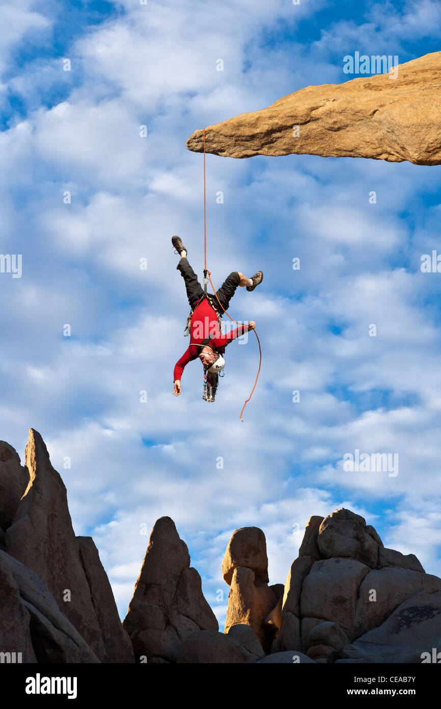 Climber in trouble at the end of his rope Stock Photo - Alamy