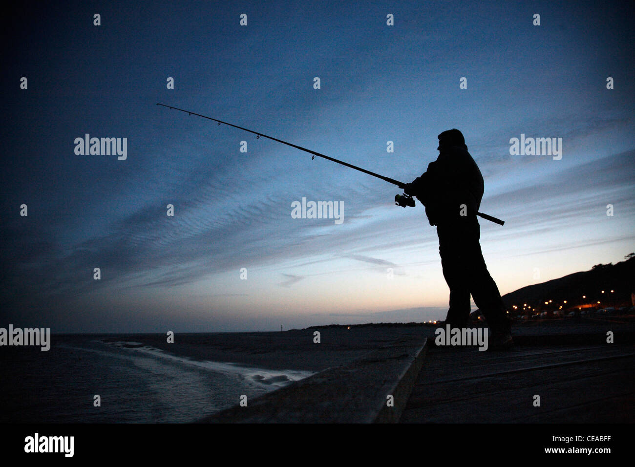 Man fishing on the coast in Barmouth Stock Photo Alamy