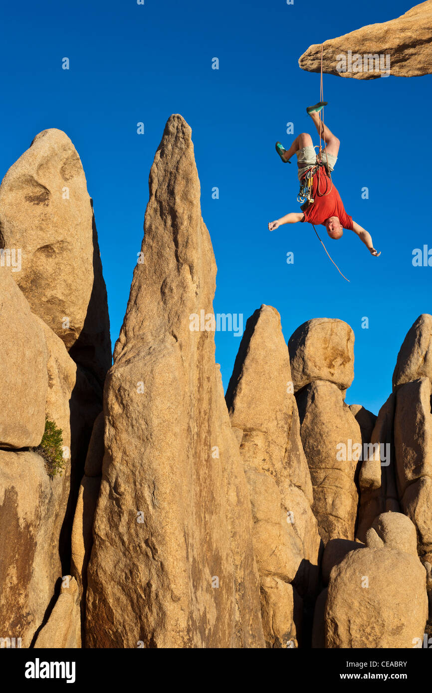 Climber in trouble at the end of his rope Stock Photo - Alamy