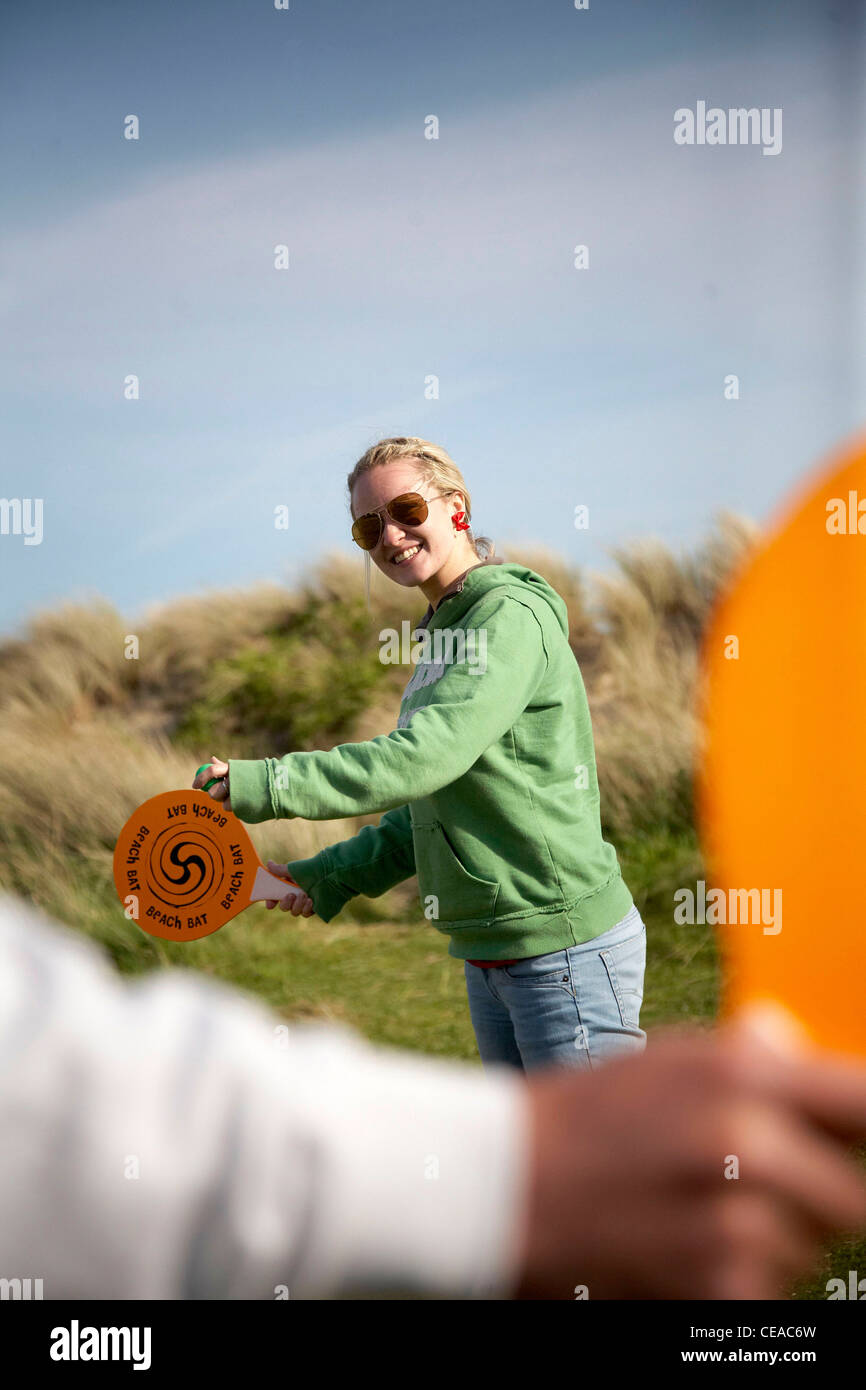 Couple playing a racket game on holiday Stock Photo