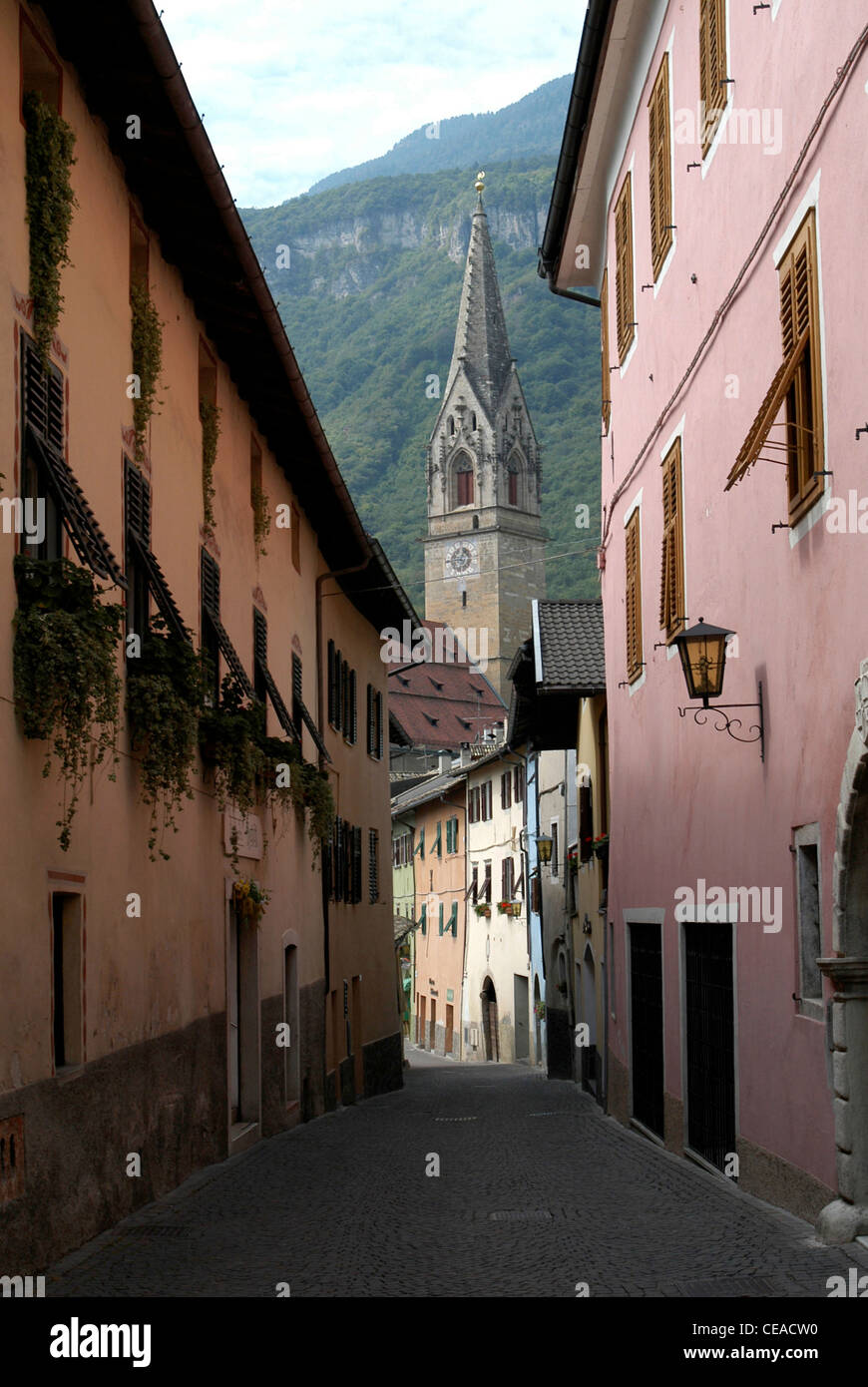 Old lane in Tramin at the South Tyrolean wine route with the Gothic Parish church from the 15th century. Stock Photo