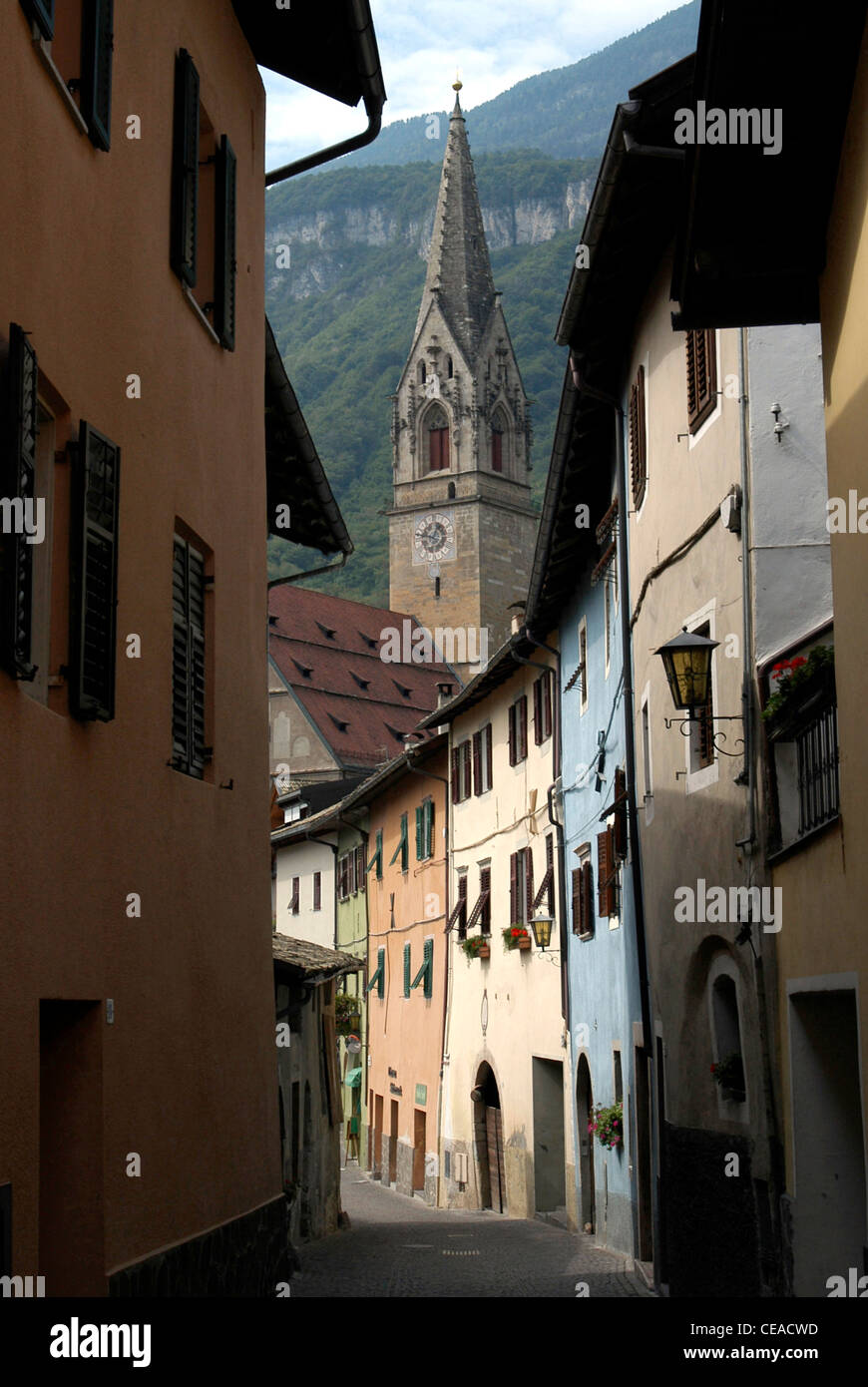 Old lane in Tramin at the South Tyrolean wine route with the Gothic Parish church from the 15th century. Stock Photo