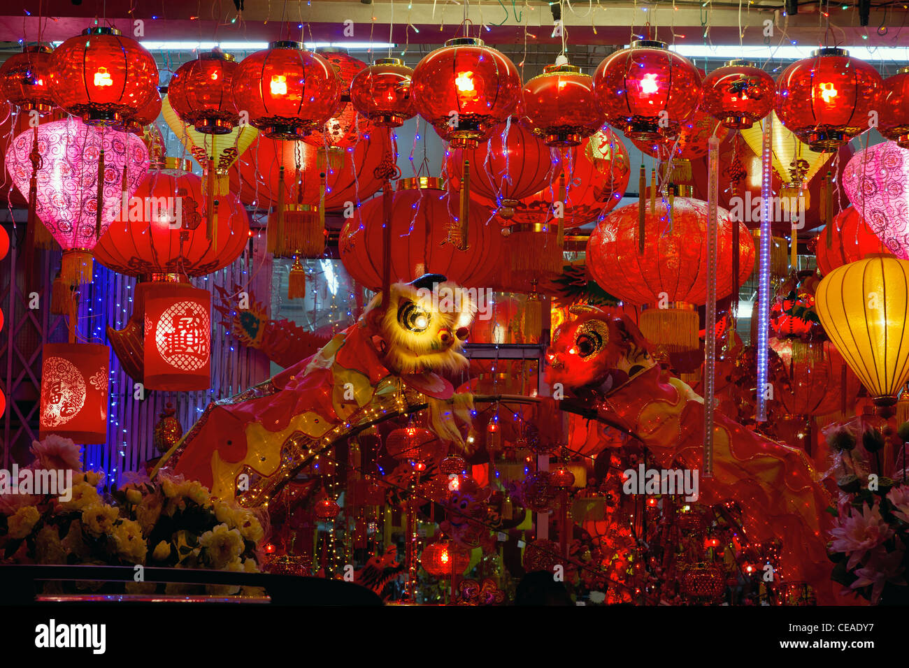 Storefront Displays of Chinese New Year Lanterns and Lion Dance along Street in Chinatown Stock Photo