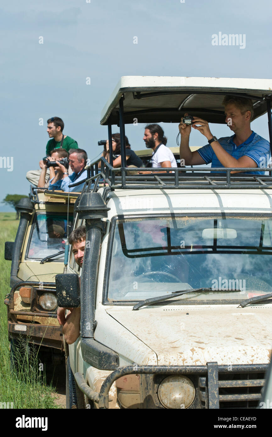 Tourist watching wildlife from their cars at Maasai Kopjes in Serengeti, Tanzania Stock Photo