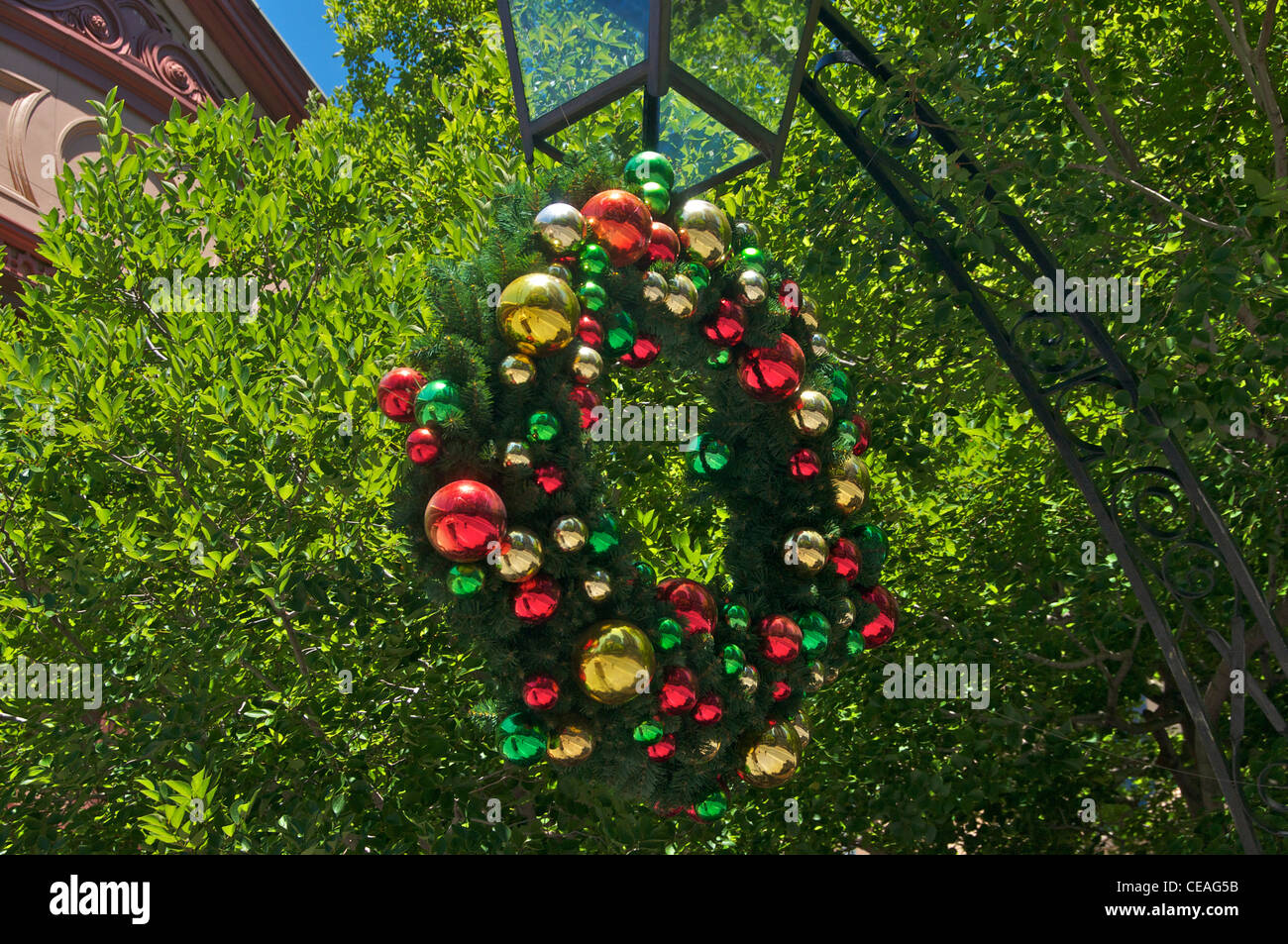 Christmas Wreath With Colourful Decorations Hanging From A Lamp