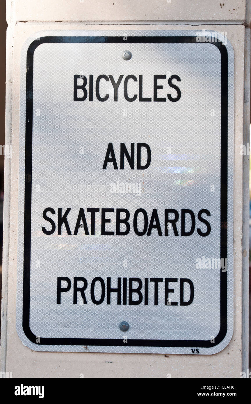 Bicycles and skateboards prohibited black white information sign on university area,USA Stock Photo