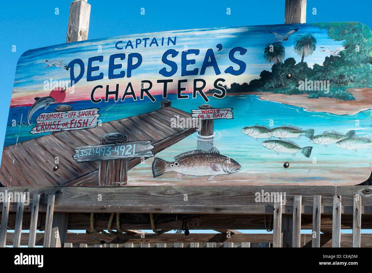Captain Deep Sea Charters sign with blue sky background, Cedar Key, Florida, United States, USA Stock Photo