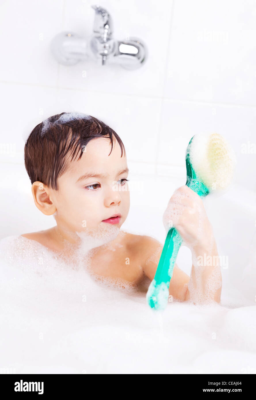 Cute Four Year Old Boy Taking A Relaxing Bath With Foam And Using A 