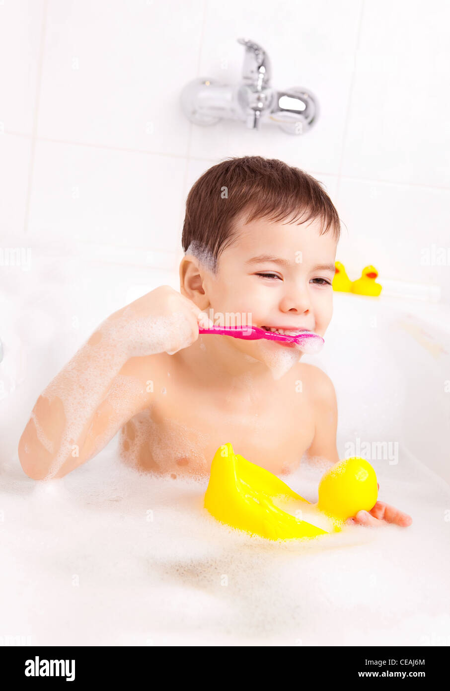 Cute Four Year Old Boy Taking A Bath With Foam And Brushing Teeth Stock 