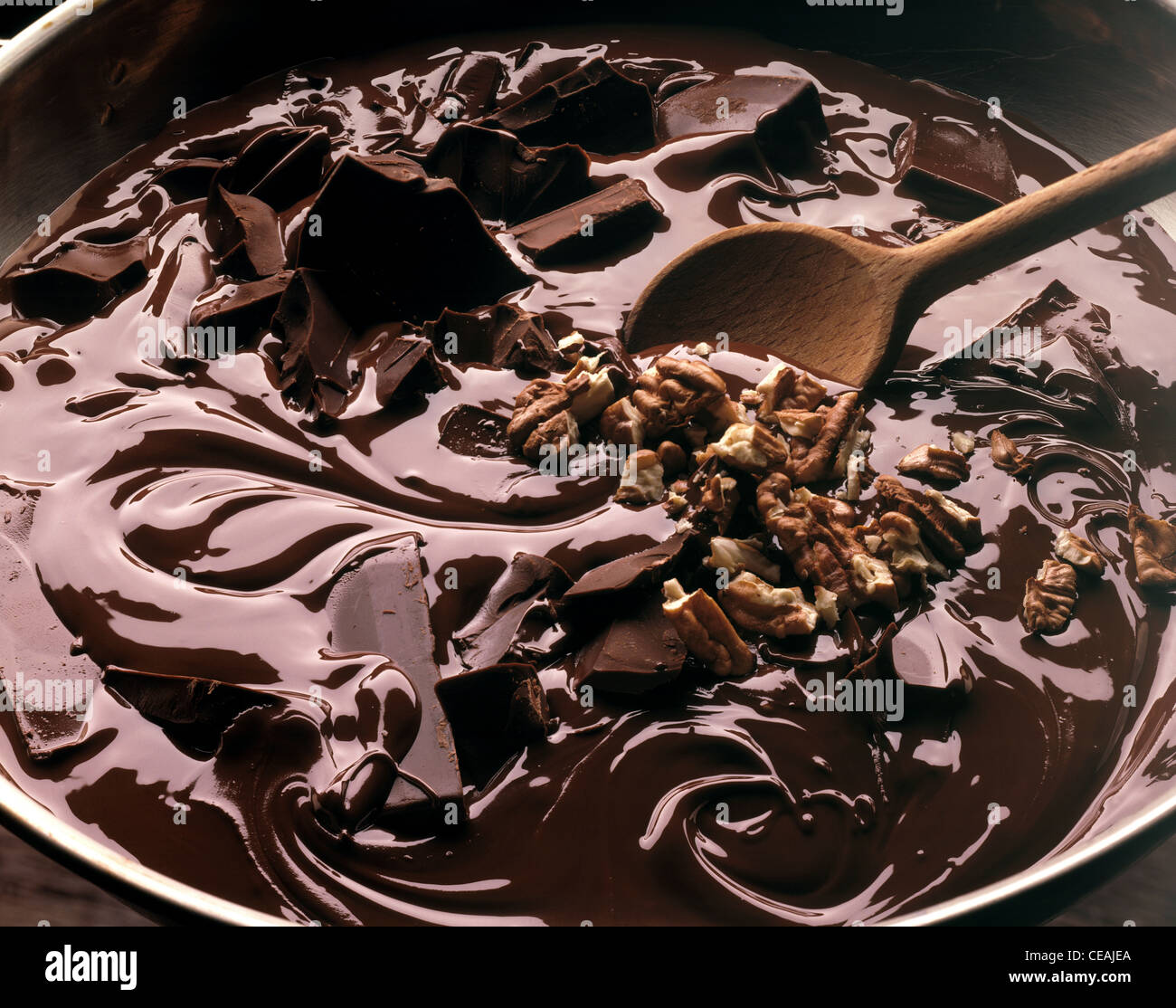 Still Melted Bittersweet Chocolate With Roughly Chopped Pecan Nuts Stock Photo Alamy