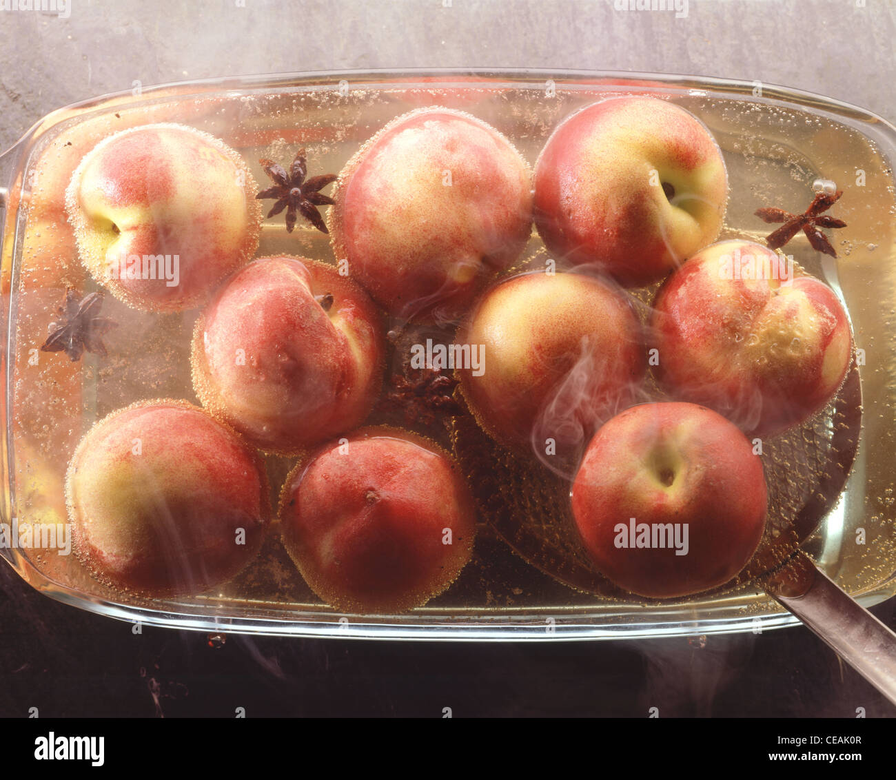 Cooking peaches in white wine Stock Photo Alamy