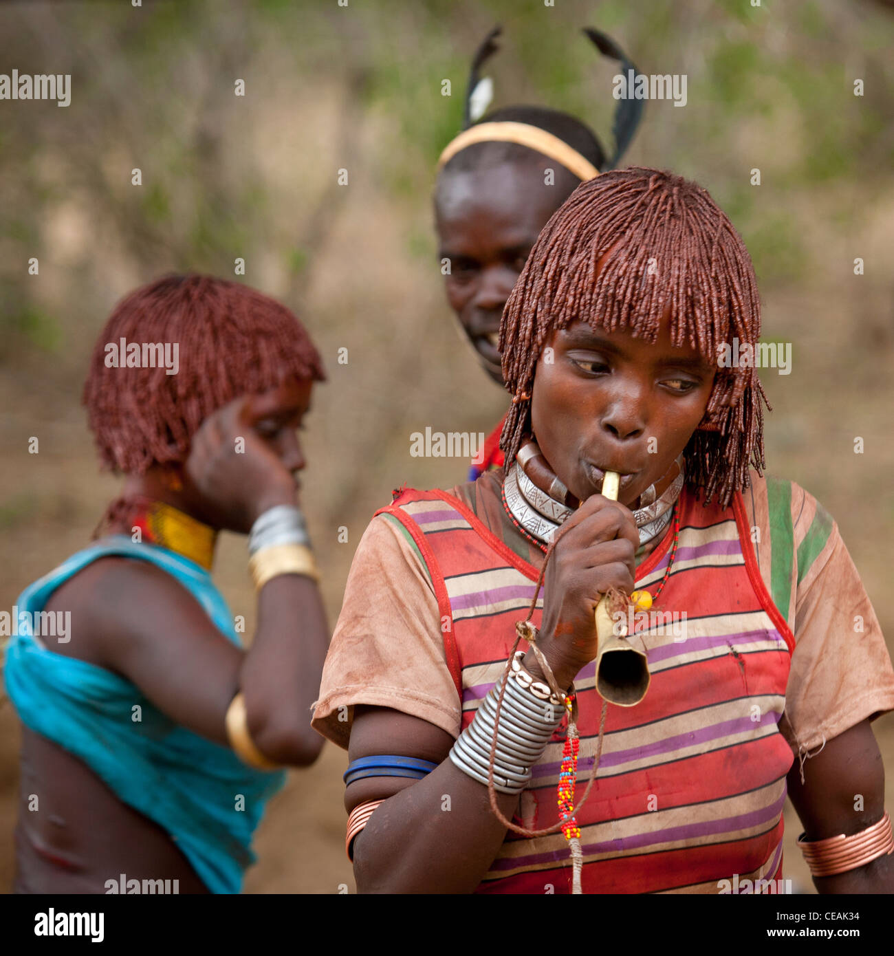 Hamer Woman With Ochred Hair Blowing A Horn Omo Valley Ethiopia Stock Photo