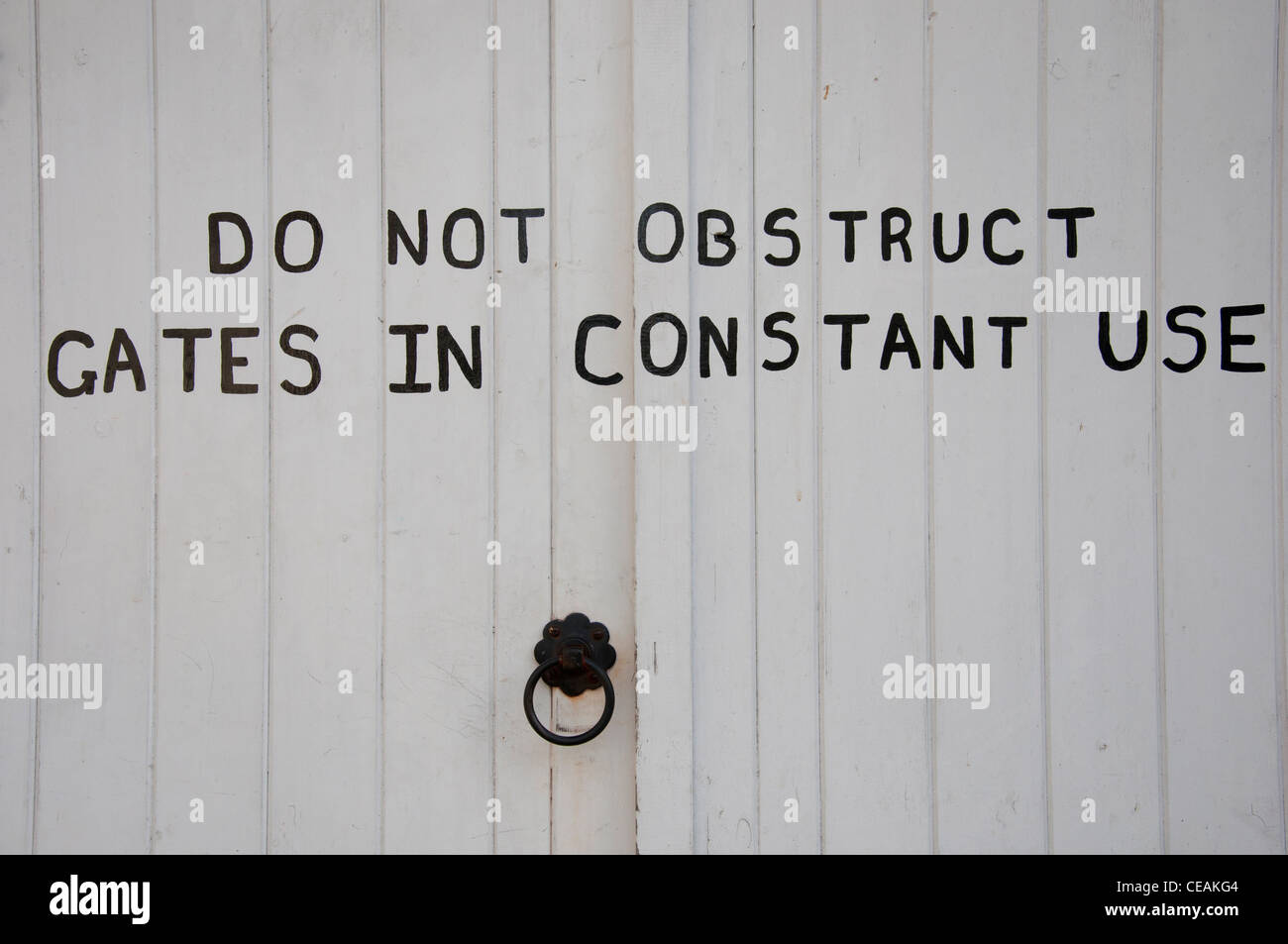Wooden garage doors with do not obstruct sign. Stock Photo