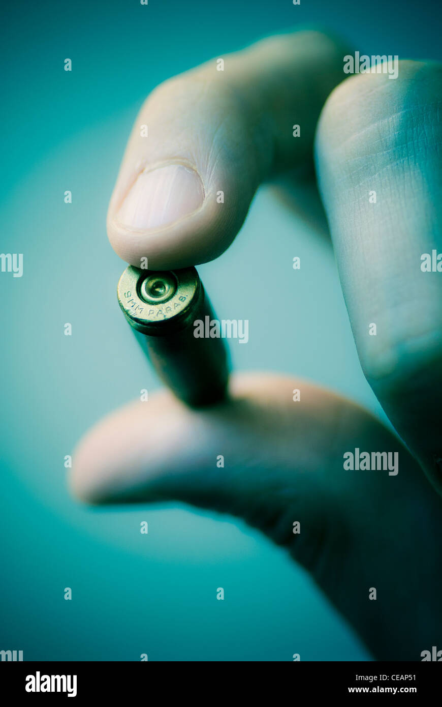Hand holding bullet Stock Photo