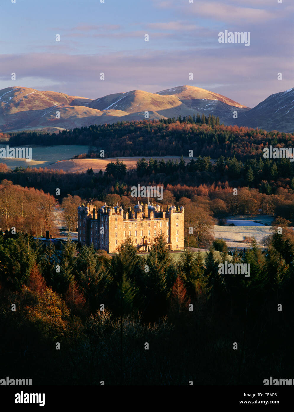 Sunrise winter snow on the Lowther Hills behind Drumlanrig Castle in scenic landscape of the Nith Valley, Nithsdale, Scotland UK Stock Photo