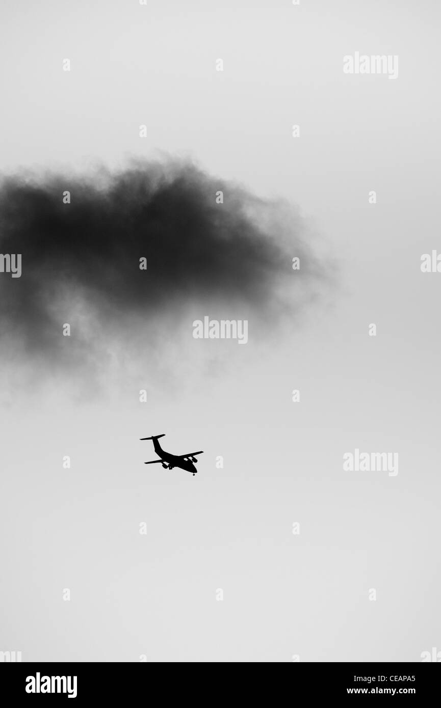 Airplane and dark cloud Stock Photo