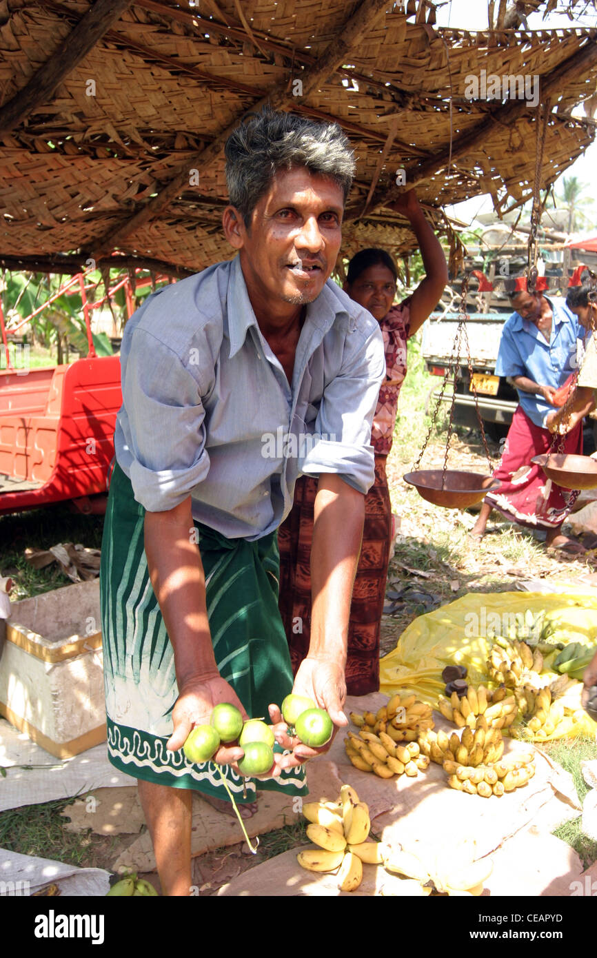 A man selling fruit at a market, Hikkaduwa, Sri Lanka Stock Photo