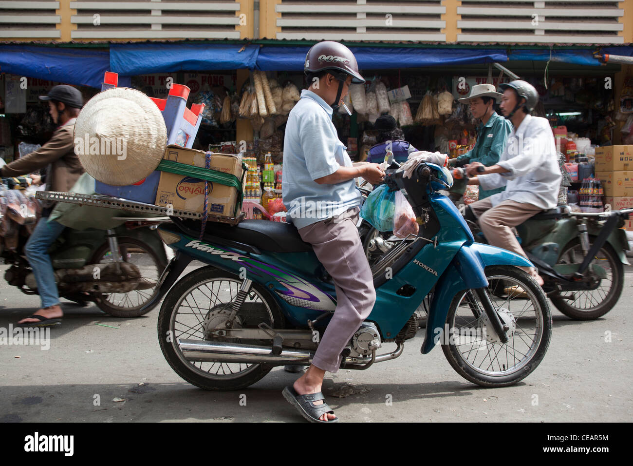 Motor bike delivery driver at Binh Tay Market Chinatown Cholon Ho Chi Minh City Stock Photo
