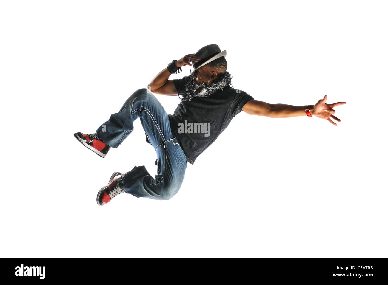 Hip Hop Dancer Jumping wearing a hat and isolated on a white background Stock Photo