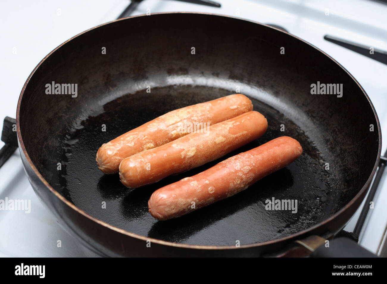 frying sausages on a pan Stock Photo Alamy