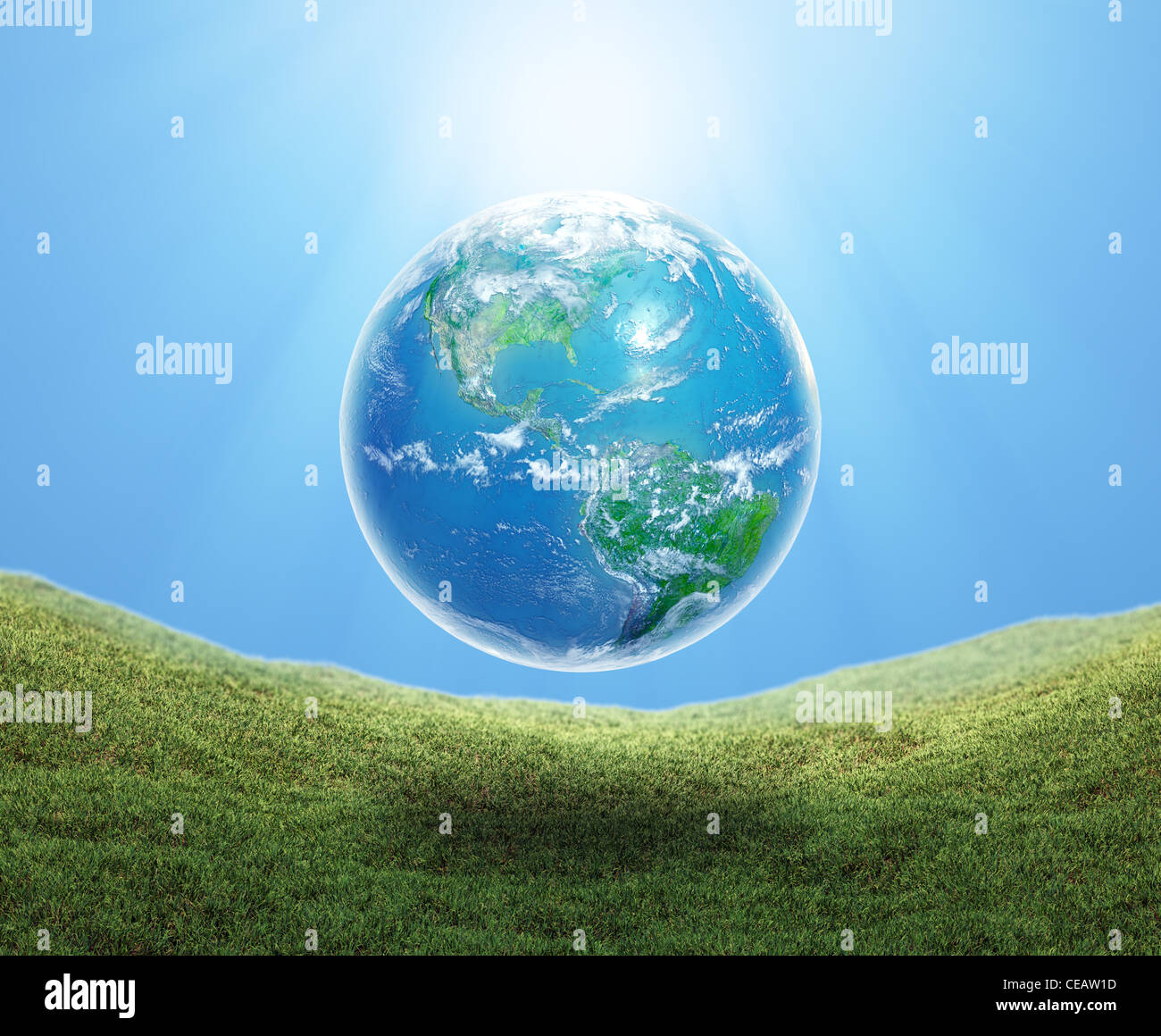 Earth floating over a grass field Stock Photo