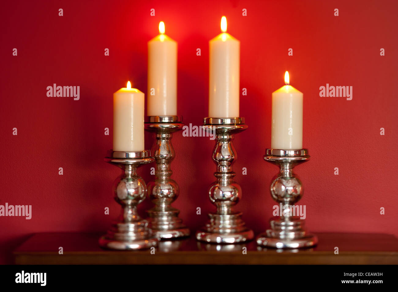 4 Candles on candlesticks Stock Photo Alamy