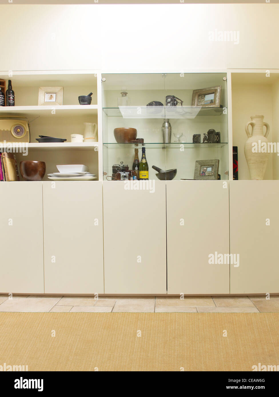 cream fitted kitchen with ornaments Stock Photo Alamy