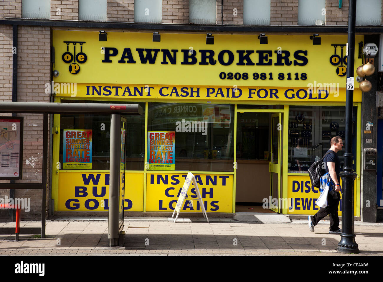 Pawnbrokers shop in East London. A pawnbroker is an individual or business (pawnshop or pawn shop) that offers secured loans. Stock Photo