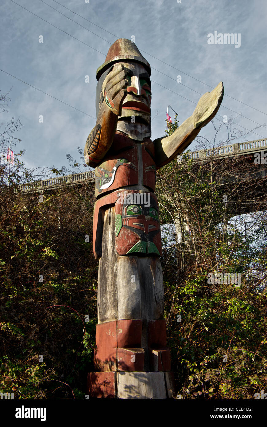Coast Salish carved wooden figure pole on First Nations land