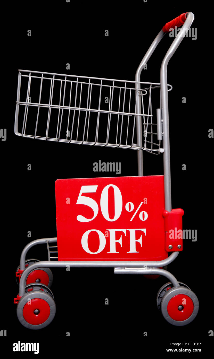 Shopping trolley with 50 percent off sign on black background Stock Photo