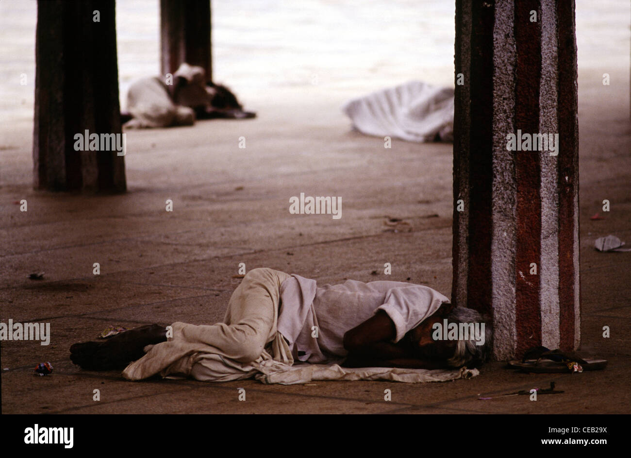 Hindu pilgrims sleep at a courtyard in Ramanathaswamy Temple dedicated