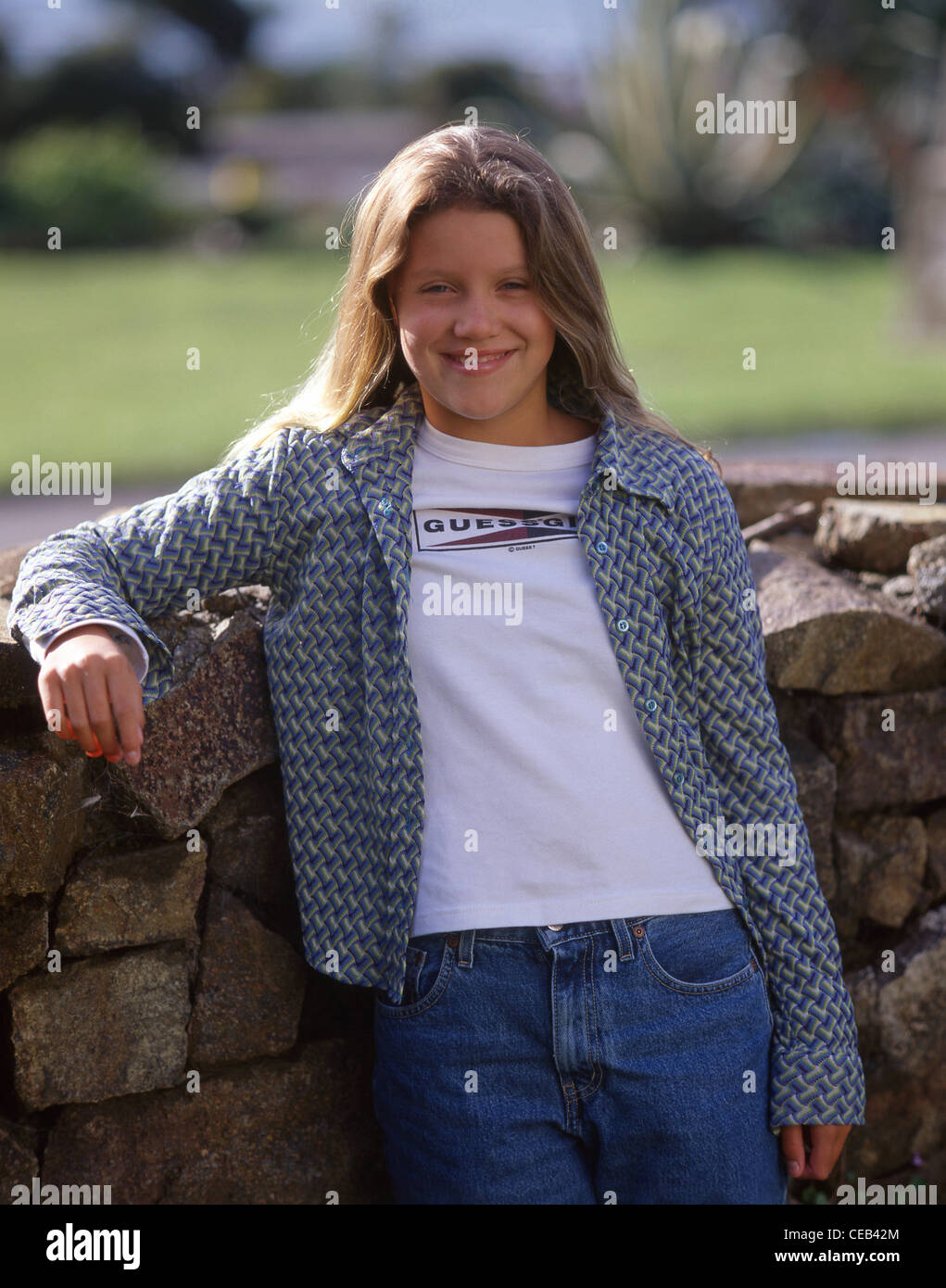 Young teenage girl by wall, Sumner, Christchurch, Canterbury Region, New Zealand Stock Photo