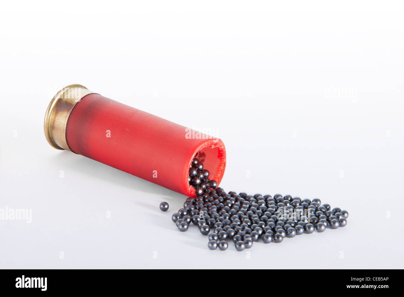 A shotgun red cartridge in horizontal position, open at the top 