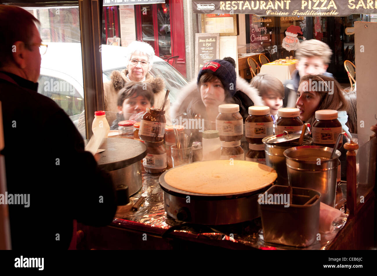 some boys in front a creperie shop Stock Photo