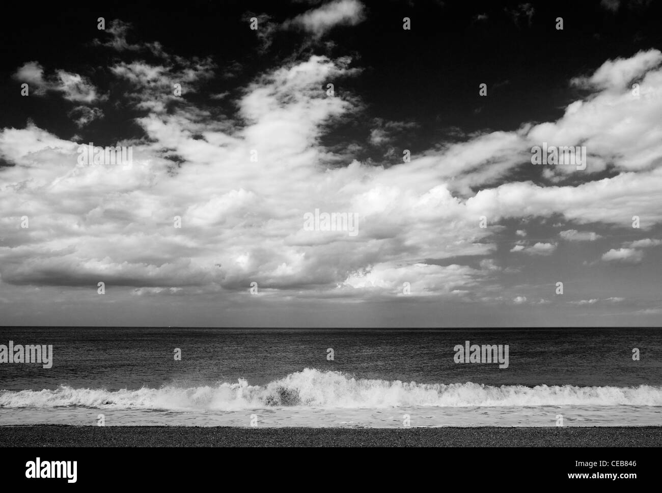 View across a shingle beach out to sea Stock Photo