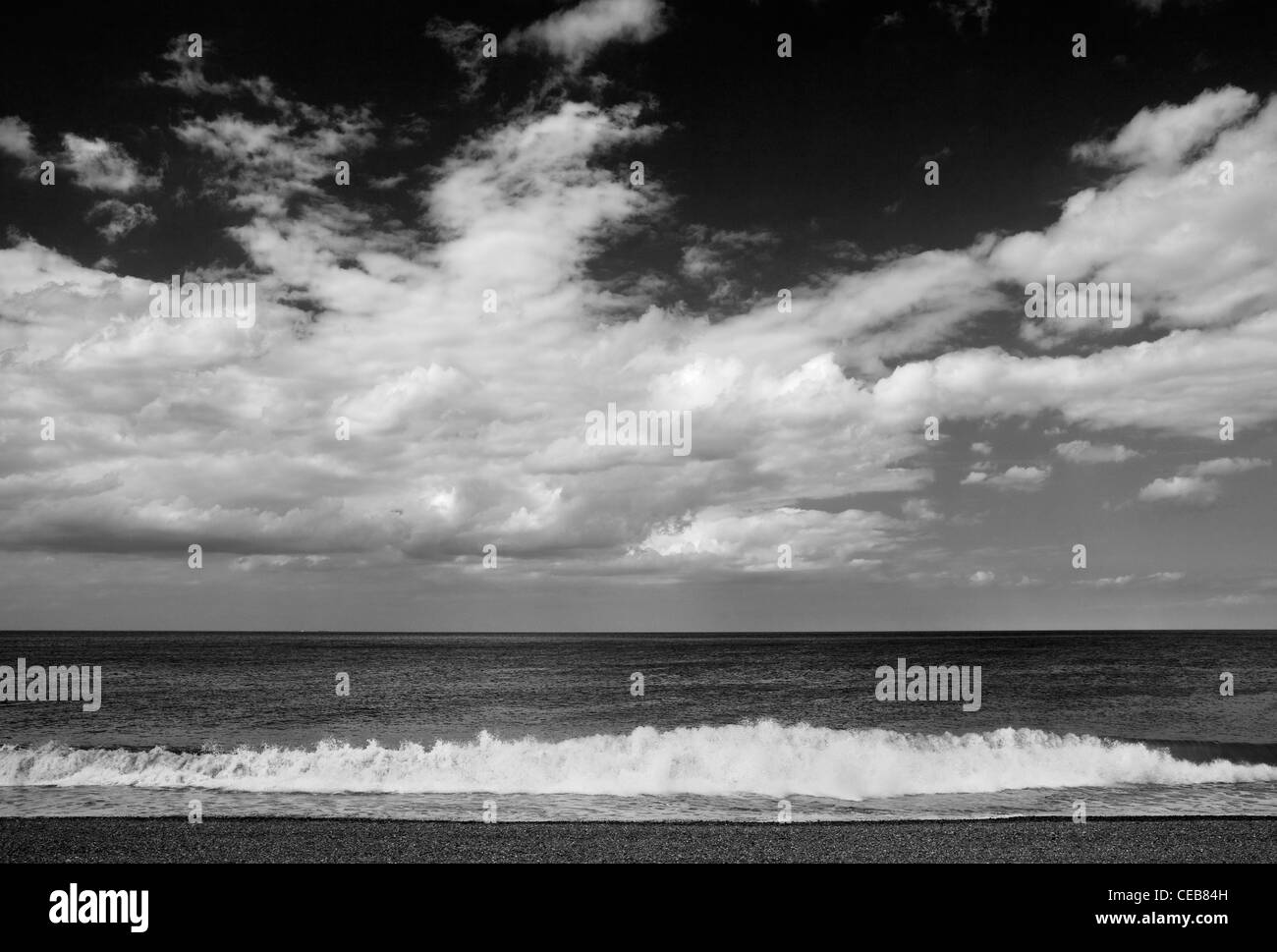 View across a shingle beach out to sea Stock Photo