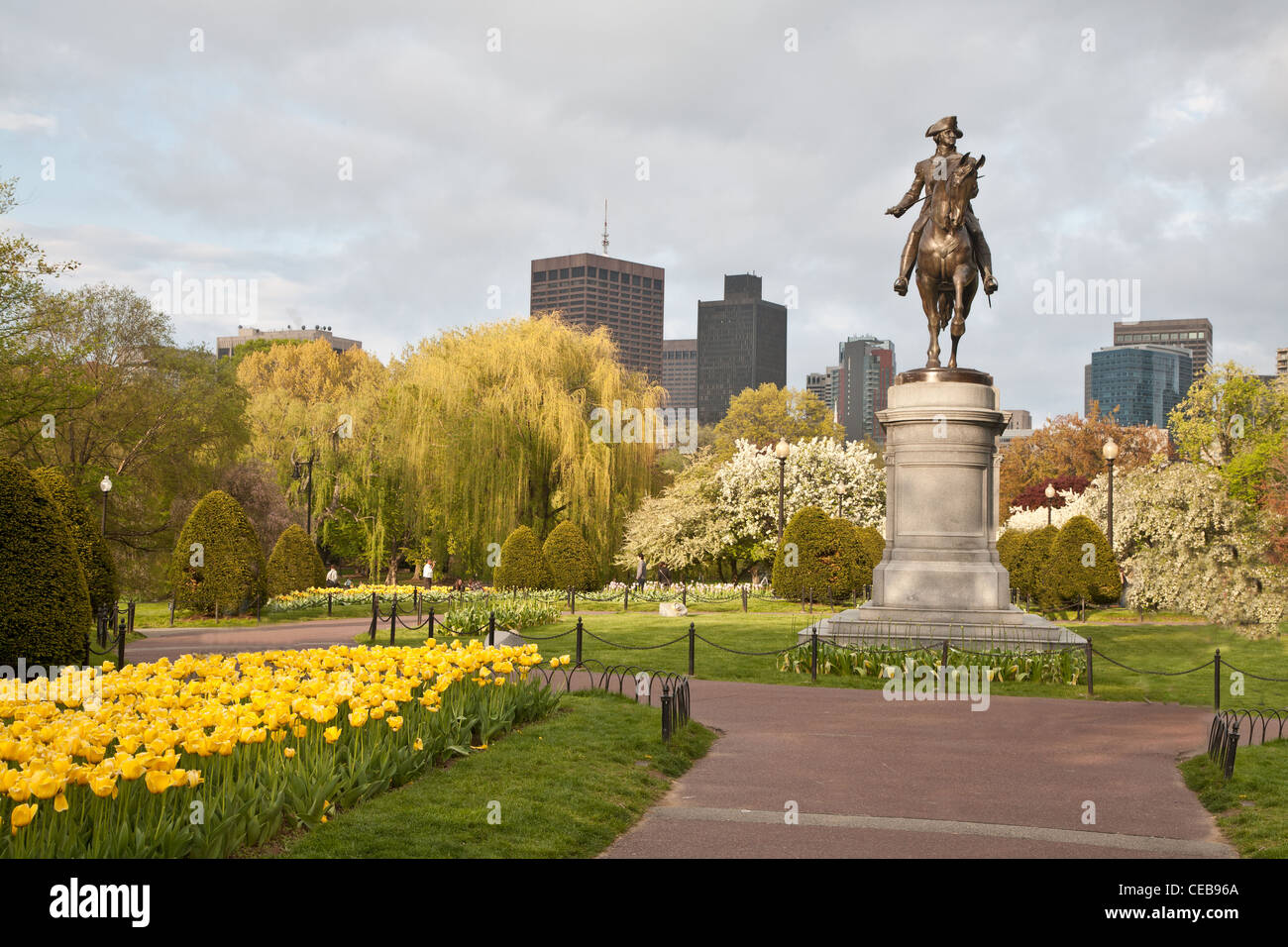 Boston Public Garden in spring with yellow tulips and statue of George Washington Stock Photo