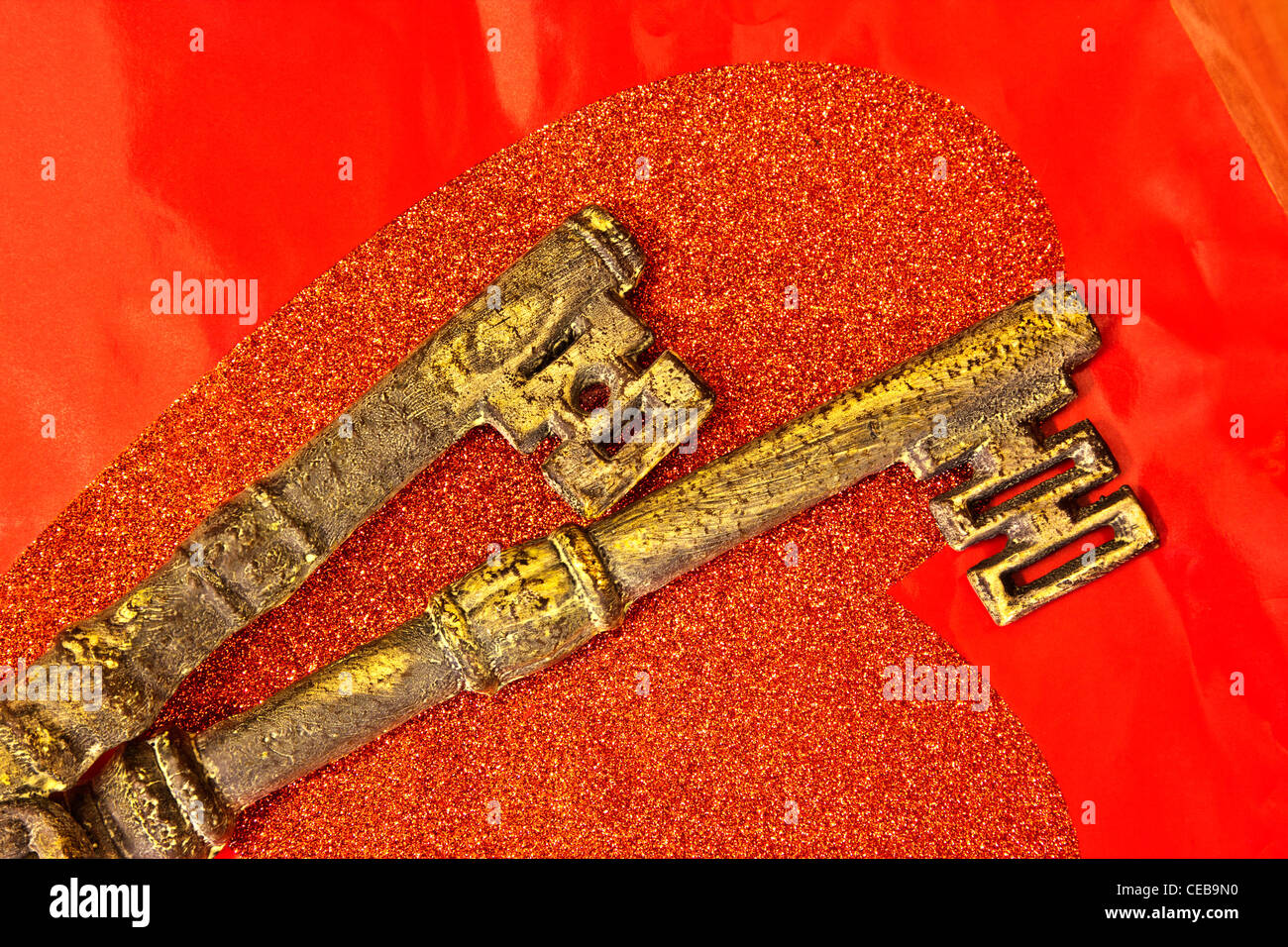 Ornate brass keys, red heart Stock Photo
