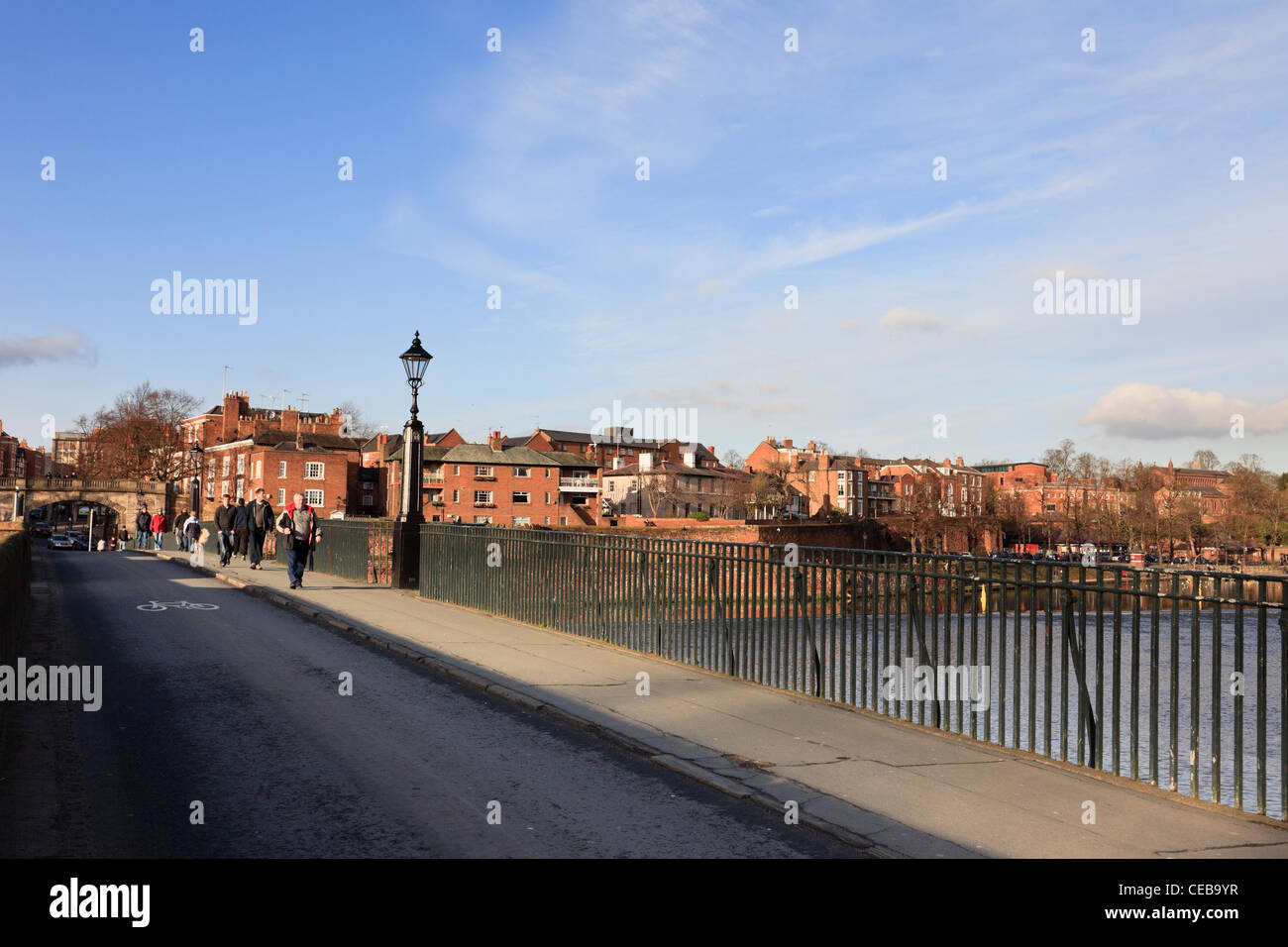 Chester, Cheshire, England, UK. People crossing the Old Dee Bridge across the river from the city Stock Photo