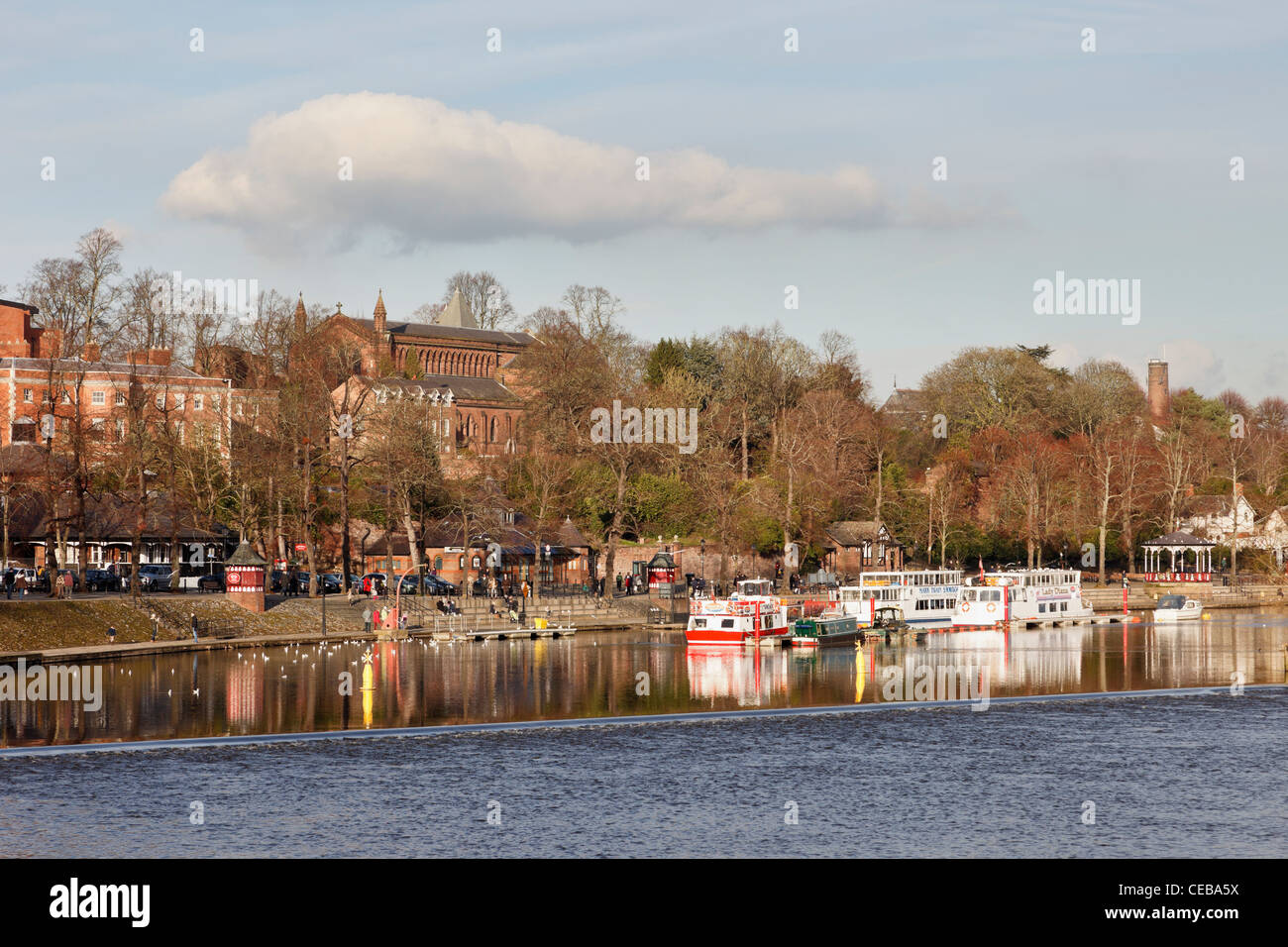 Chester, Cheshire, England, UK. View upstream across the weir on the River Dee to showboats by The Groves Stock Photo