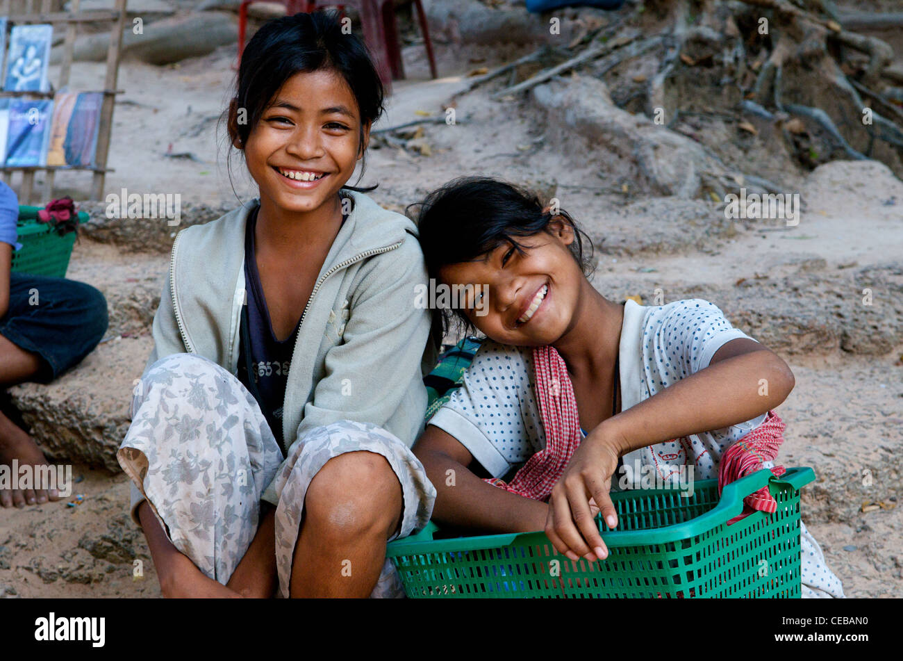 Young, happy Khmer girl vendors (1 girl wears a Krama / traditional Cambodian scarf), Preah Khan, Temples of Angkor, Cambodia. credit: Kraig Lieb Stock Photo