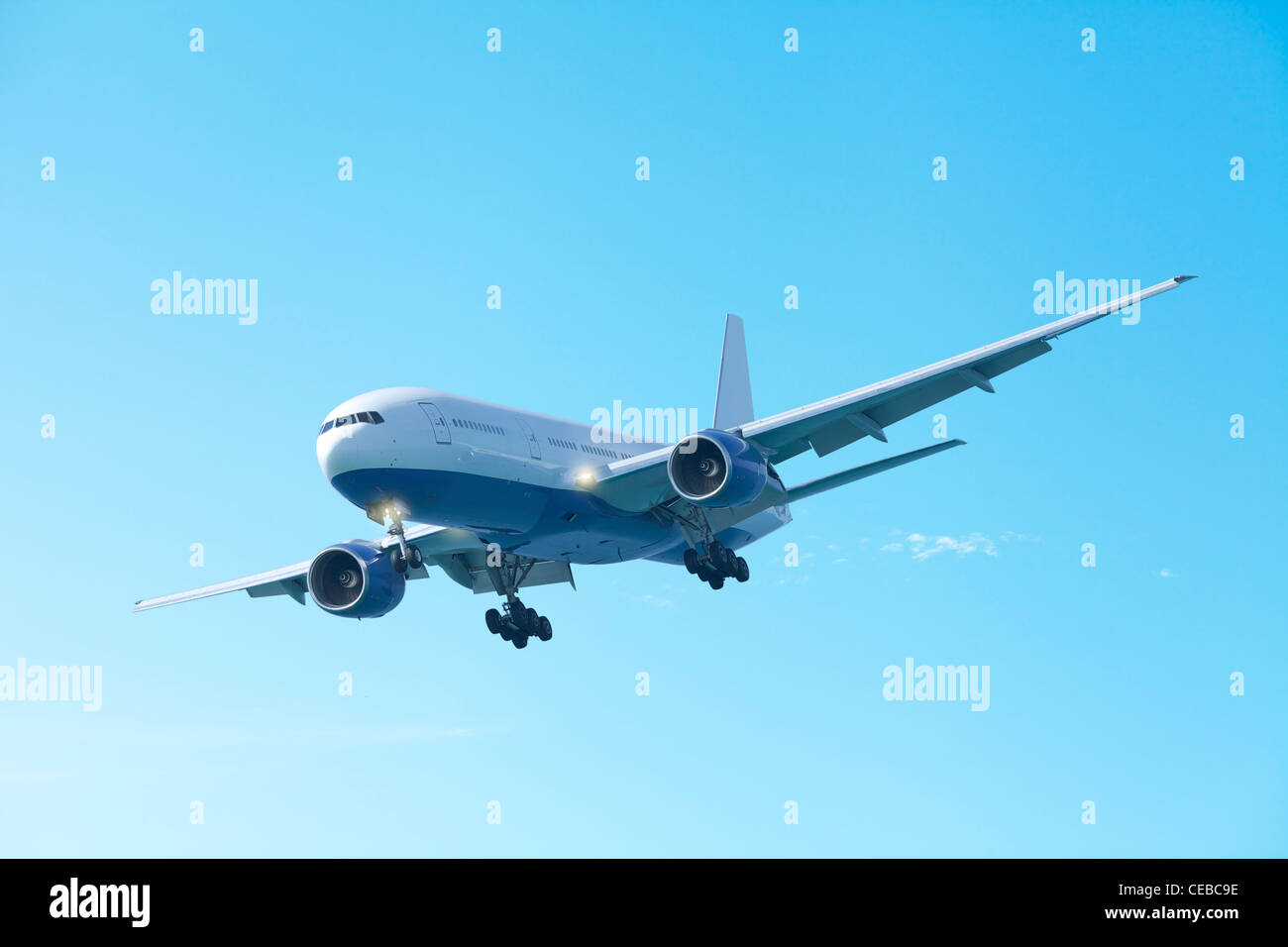 Jet plane in a clear blue sky Stock Photo - Alamy