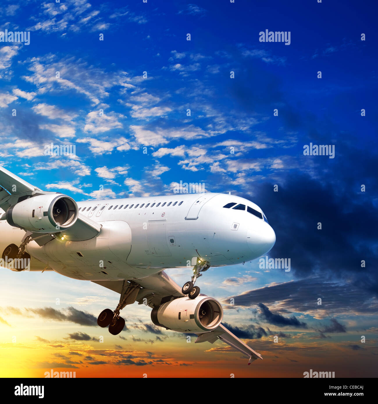 Jet plane in a sunset sky. Square composition. Stock Photo