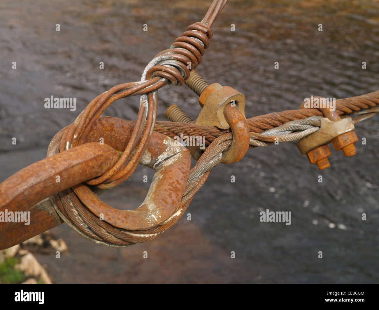 Supporting wires, metal, links and bolts for a sheep bridge over a river in the Scottish Highlands Stock Photo