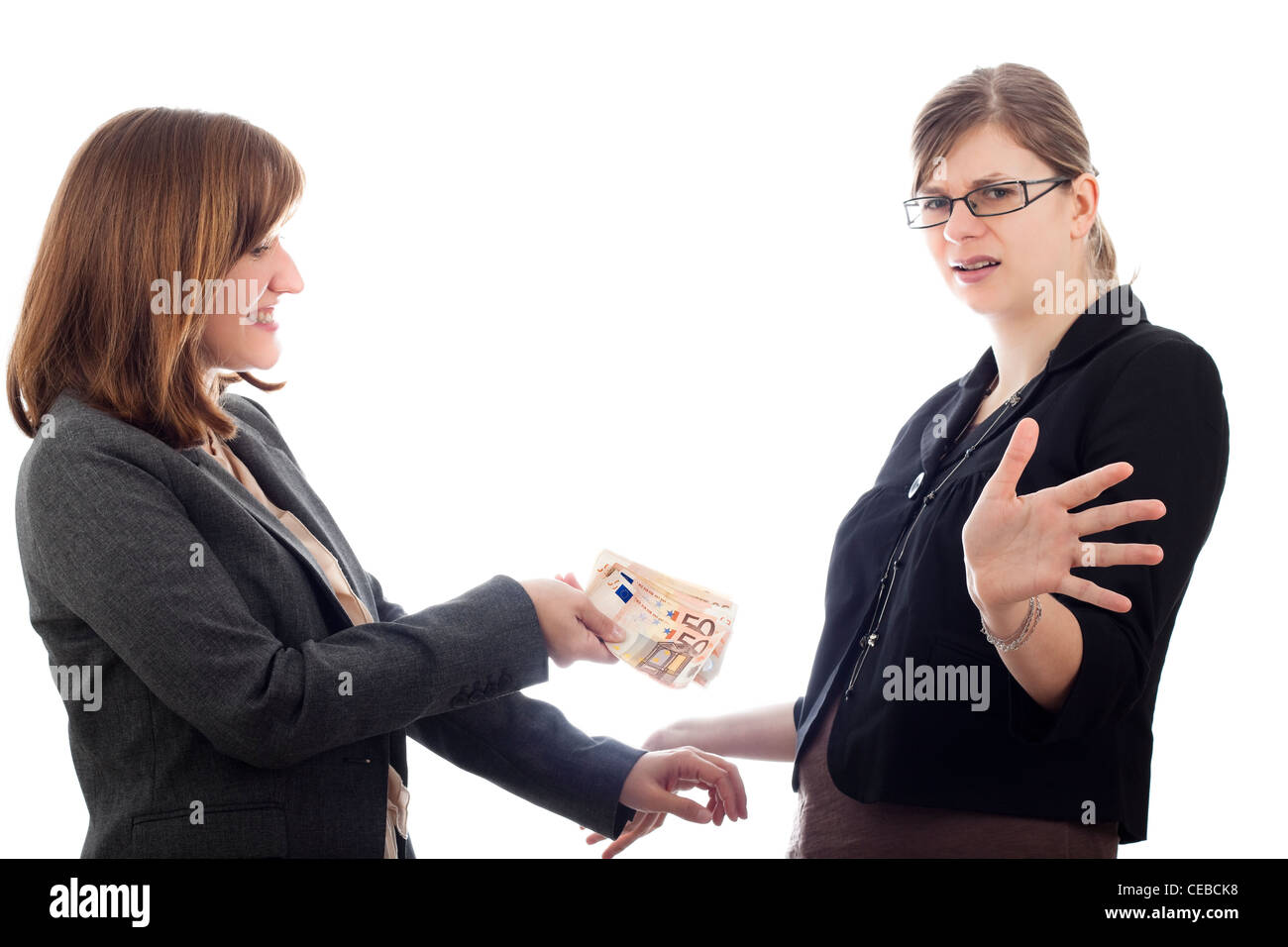 Two corrupted business women bribe with Euro bank notes, isolated on white background. Stock Photo