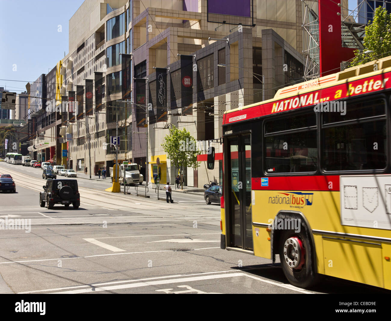 Bus entering crossing at intersection of La Trobe and Elizabeth Streets, Melbourne, Victoria, Australia Stock Photo